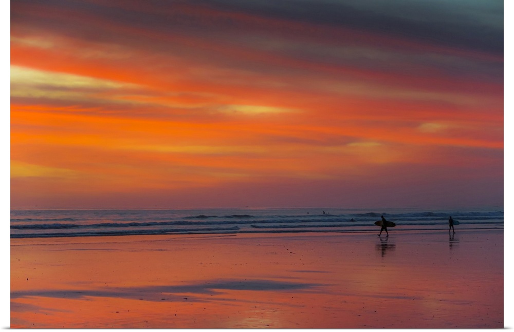 Surfer silhouetted on Guiones Beach where many come to relax and surf at sunset, Playa Guiones, Nosara, Guanacaste, Costa ...
