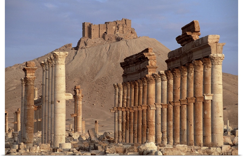 The Great Colonnade, with Arab castle on hill in background, Palmyra, Syria
