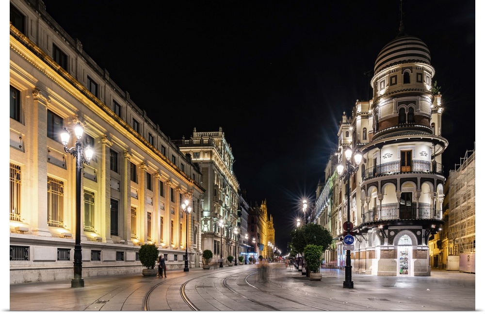 The lights of Seville's buildings at night looking down the Avenida de la Constitucion towards the Catedral de Sevilla, Se...