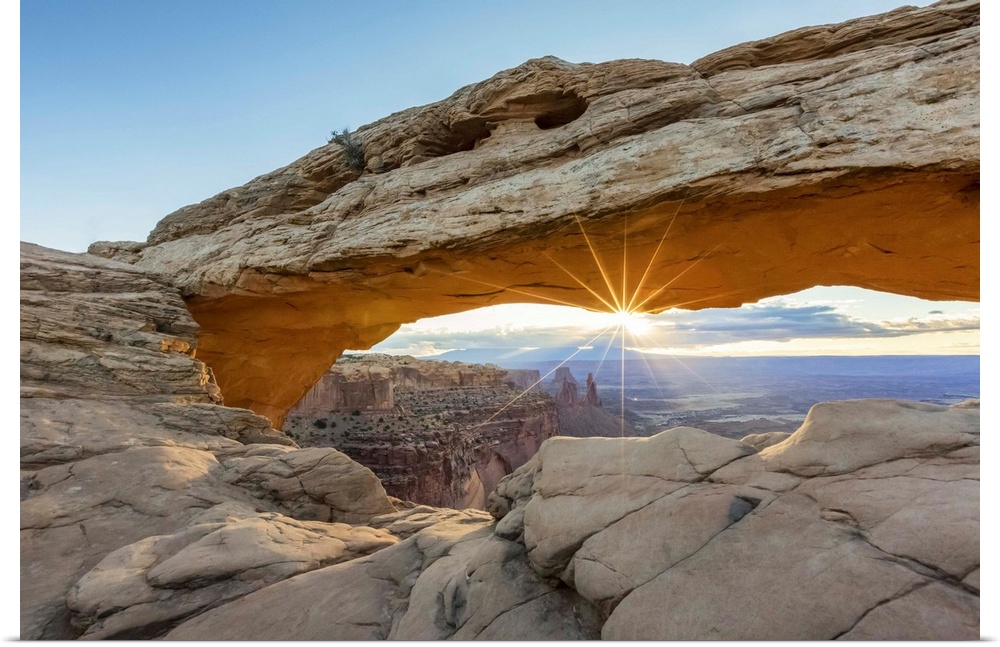 The sun is rising under Mesa Arch, Canyonlands National Park, Moab, Utah, United States of America, North America