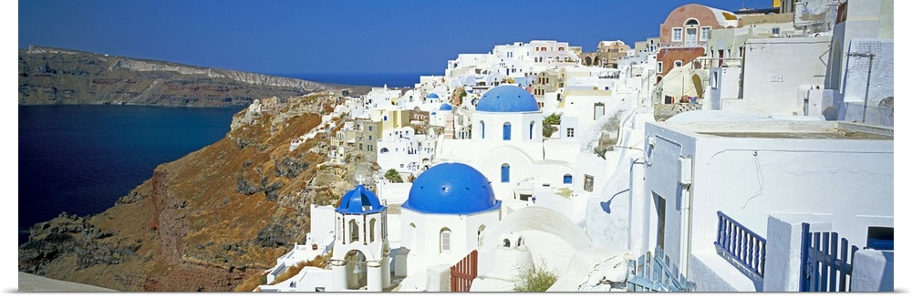 View of Oia with blue domed churches, Santorini, Greek Islands, Greece