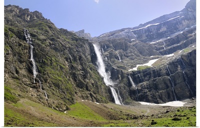 Waterfalls cascade down the karst limestone cliffs, Hautes-Pyrenees, France