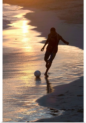 Young man playing football at sandbeach in twilight, Sal, Cape Verde, Africa