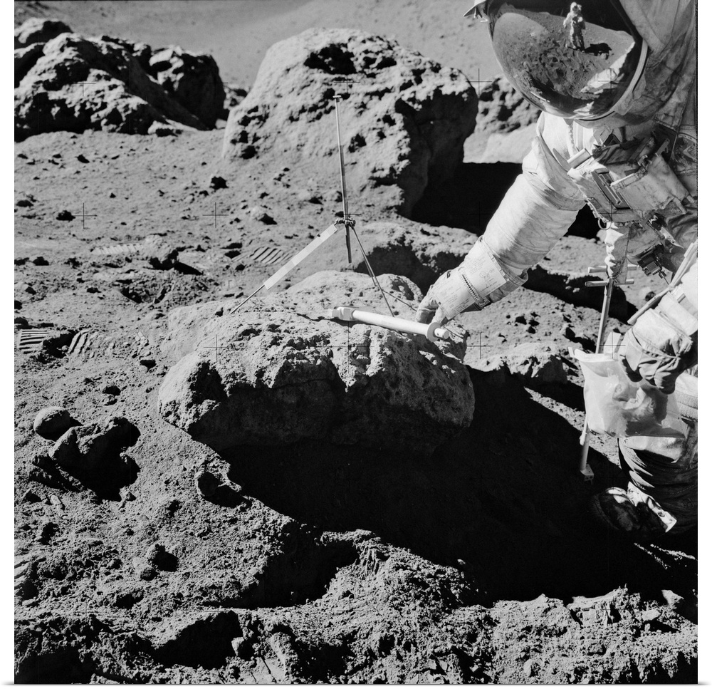 Apollo 15 lunar rock sampling, August 1971. US astronaut David Scott reaching for the geology hammer he has been using to ...