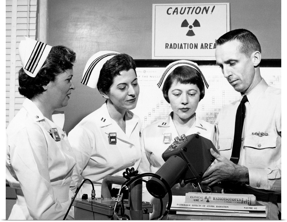 Cold War medical training. US Navy nurses observing a demonstration of radiation survey instruments as part of the nuclear...