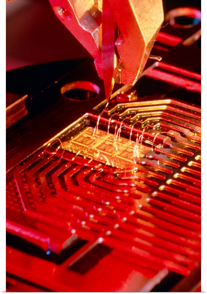 Microprocessor manufacture. A machine placing connections from a microprocessor to surrounding circuit parts. The connecti...