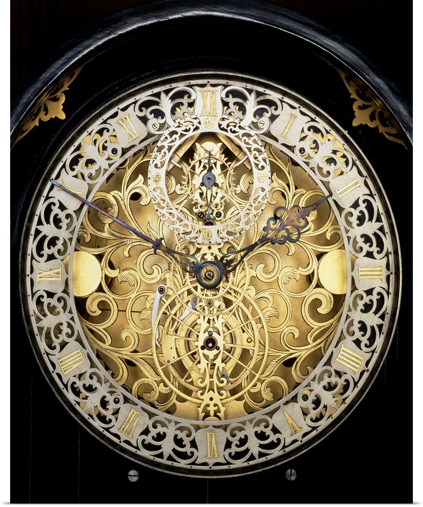Antique clock. Face of an antique skeleton clock, revealing the internal gearing. The main face shows the time in hours an...