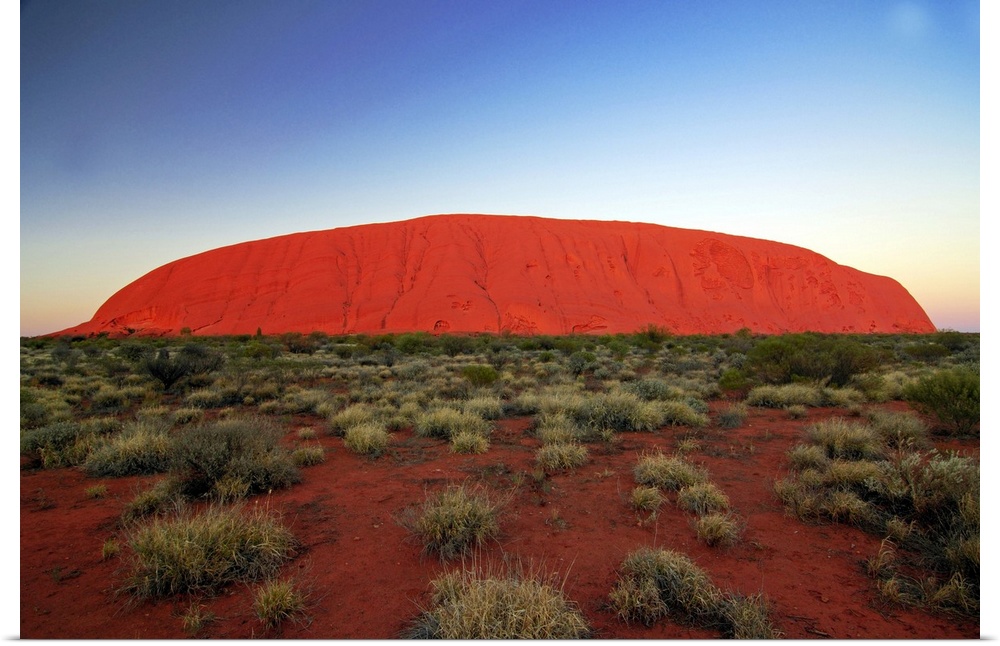 Uluru (Ayers Rock) at sunrise. Uluru is a large sandstone rock formation in the southern part of the Northern Territory in...