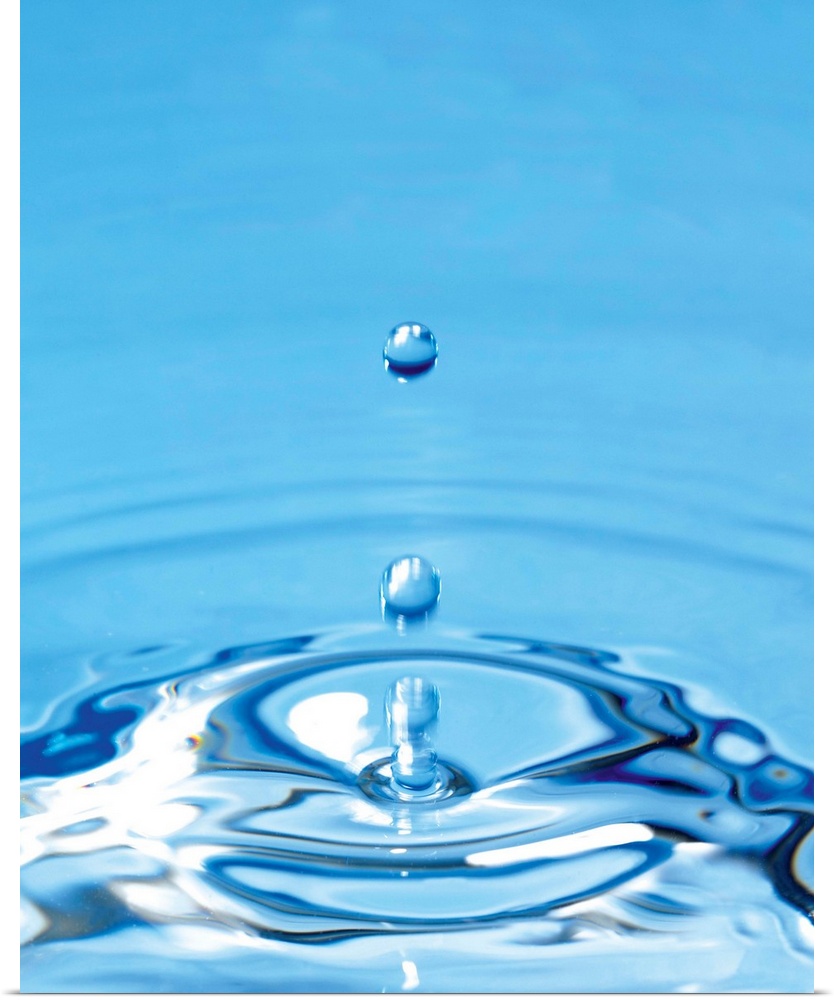 Water drop impact. High-speed photograph of secondary drop formation following the impact of a water droplet on water. The...