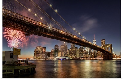 Brooklyn Bridge and fireworks over Manhattan in NYC