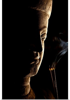 Buddha statue with incense in Mrauk, Myanmar