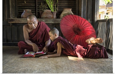 Burmese monkmaster and young monk in their monastery