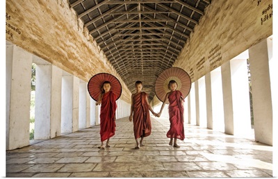 Burmese monks with parasols in their monastery, Mandalay, Burma