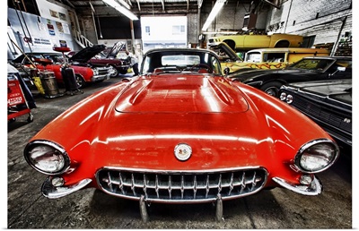Classic red corvette in a car repair shop