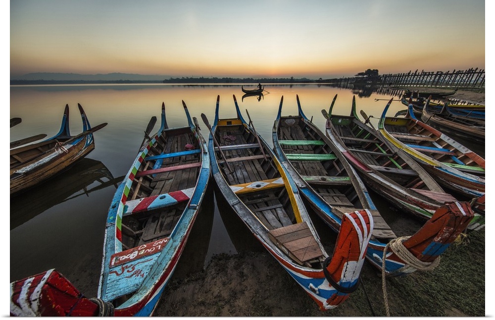 Colorful longtail boats at sunrise at the Ubein Bridge in Mandalay, Burma