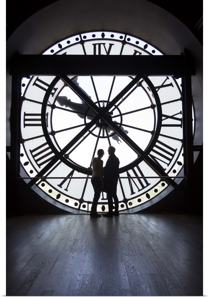 Couple by the clock inside the Musee D'Orsay in Paris