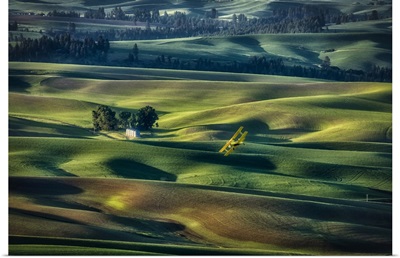 Crop Duster Flying Over The Rolling Wheat Fields Of The Palouse