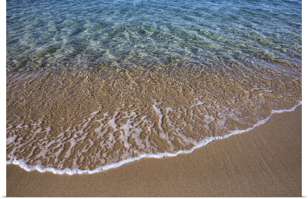 Crystal clear waves on the beach in Greece