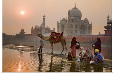 Family washing in the Yamuna River, behind the Taj Mahal, India