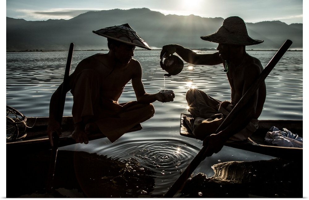Inle Lake Fisherman pouring tea in their longtail boats in Burma.