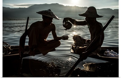 Inle Lake Fisherman pouring tea in their longtail boats in Burma