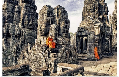 Monk boys reading on the Bayon Temple, Angkor Wat, Cambodia