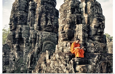 Monk reading atop temple, Angkor Wat, Cambodia