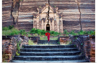 Monk with parasol walking at Mingun Pagoda, Mandalay,Burma