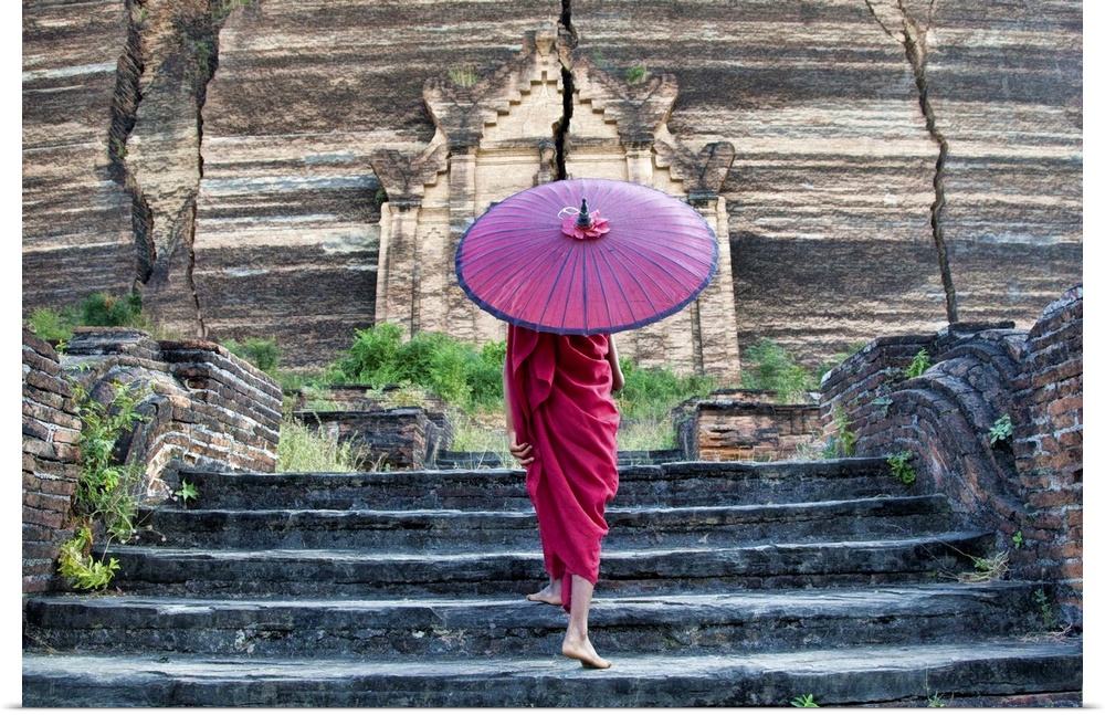 monk with parasol walking up the steps to Mingun Monastery in Burma