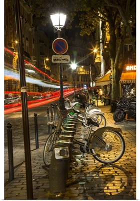 Paris street with car trails at night