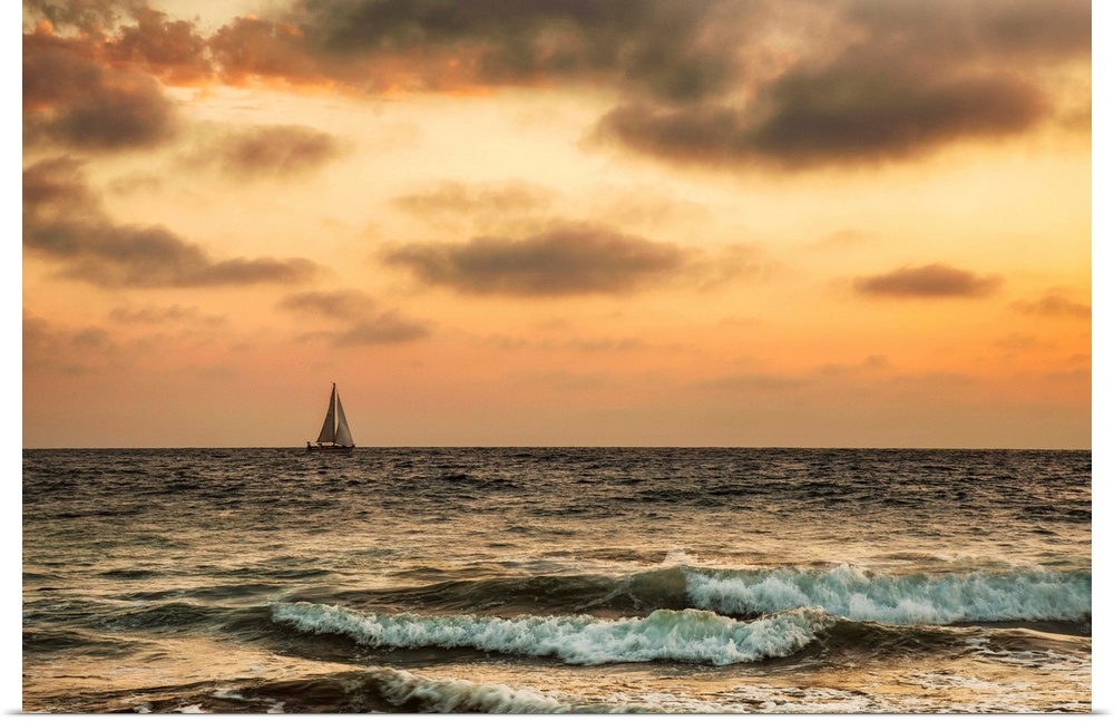 Sailboat off the coast of California at sunset.