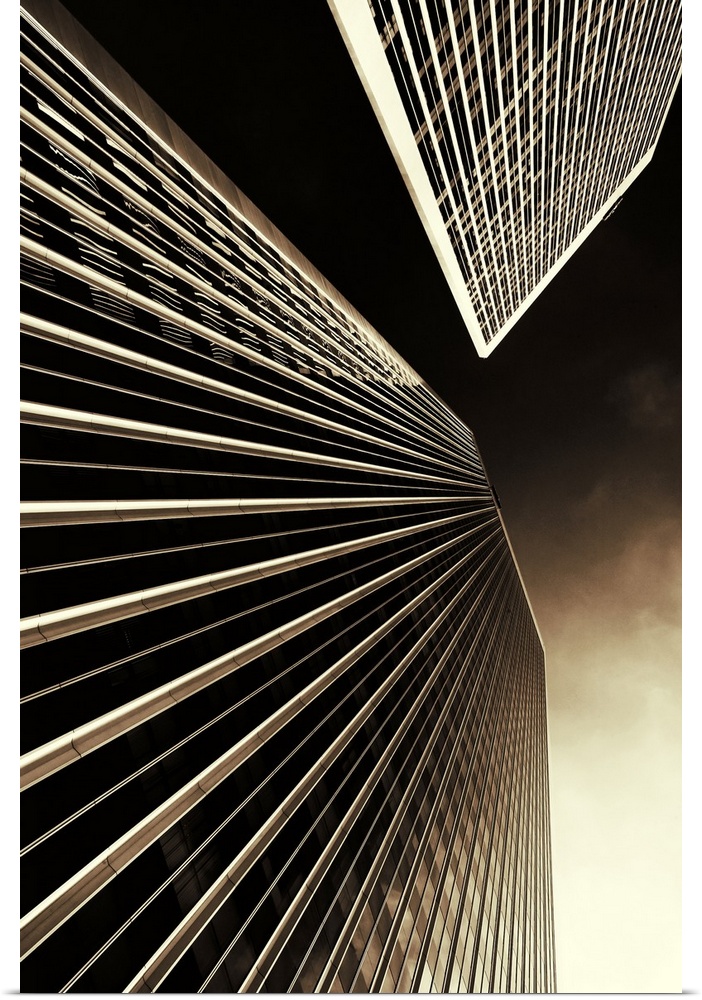 Vertical photo on canvas of the view looking upwards at two tall skyscrapers.