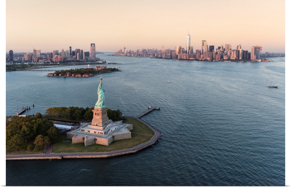 Stature of Liberty and Manhattan from above at sunset