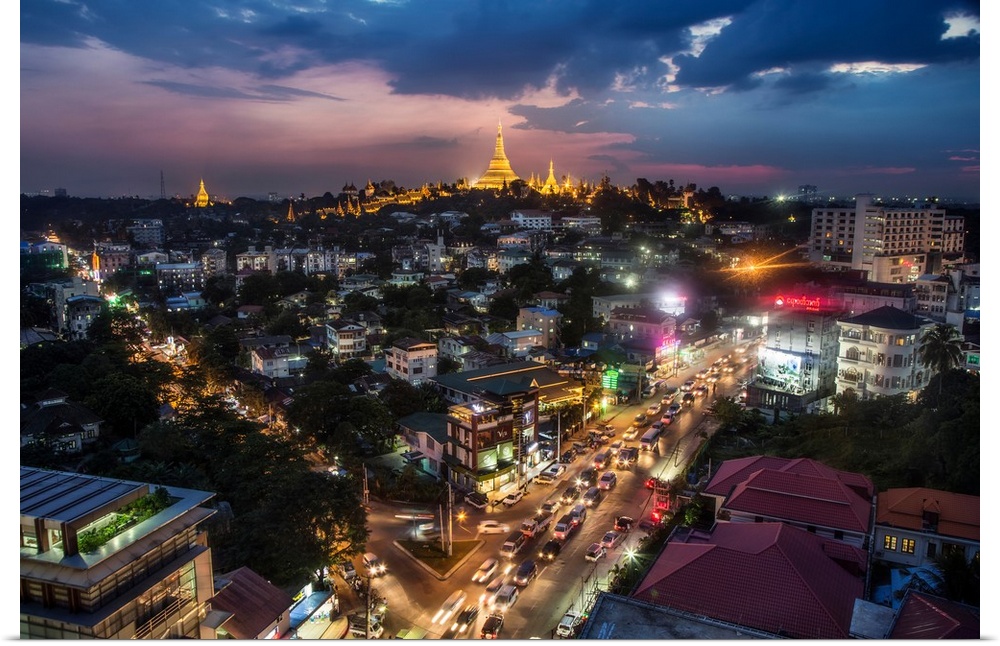 The Shwedagon Pagoda and nearby homes after dark in Yangon.