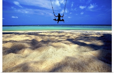Woman on swing by the ocean, Koh Samui, Thailand