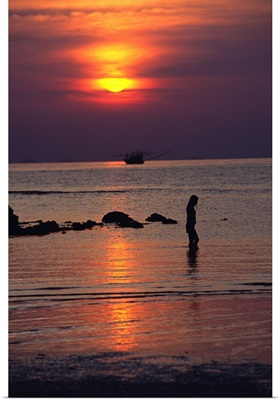 Woman walking on beach at sunset, Koh Samui, Thailand
