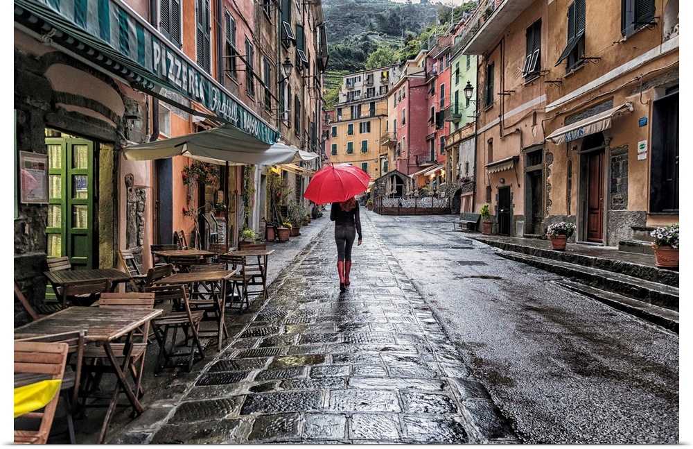 Woman with red umbrella in the rain in Vernazza, Italy