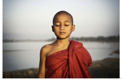 Young Burmese monk by the water, Mandalay, Burma