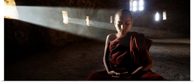 Young monk praying in his monastery, Bagan, Burma