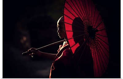 Young monk with parasol in Bagan, Myanmar