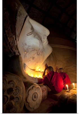 Young monks praying with Buddha, Bagan, Burma
