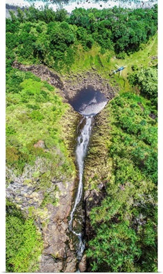 A Blue Hawaiian Helicopter Sets Down On A Remote Waterfall Near Hawaii's Shoreline