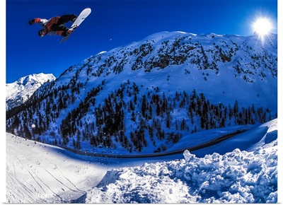 Dave Aubrey snowboarding over Julier Pass in the Swiss Alps