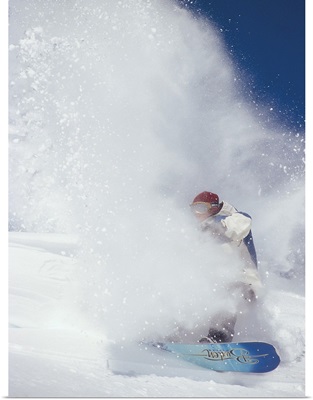 Ian Spiro in a cloud of snow, snowboarding in the North Cascades, Washington.