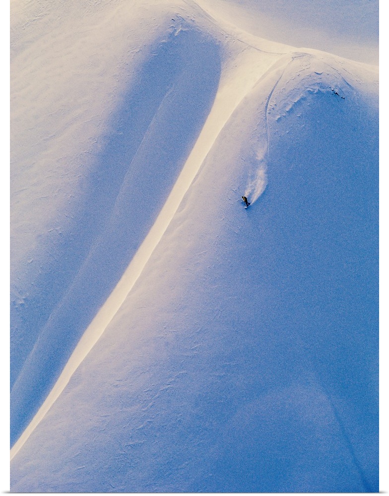 Pat Abramson snowboarding down the snowy mountainside at Tyax Wilderness Resort, TLH Heliskiing, Gold Bridge, British Colu...