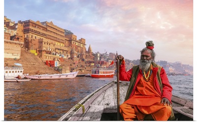 Indian Sadhu Baba Takes A Boat Ride On River Ganges Overlooking Varanasi City At Sunset