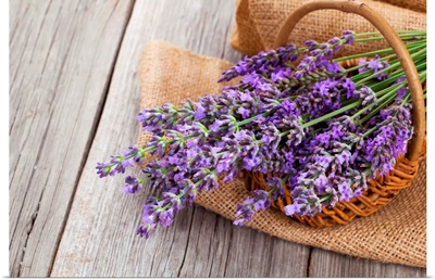 Lavender Flowers In A Basket With Burlap On The Wooden Background