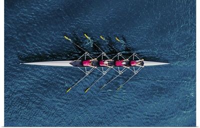Top View Of Women's Rowing Team On Blue Water