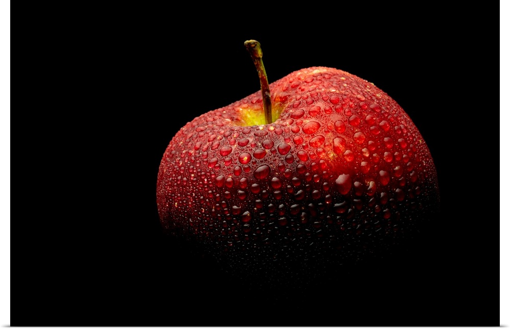 A close up photograph of a fresh Red Delicious apple with waterdrops.