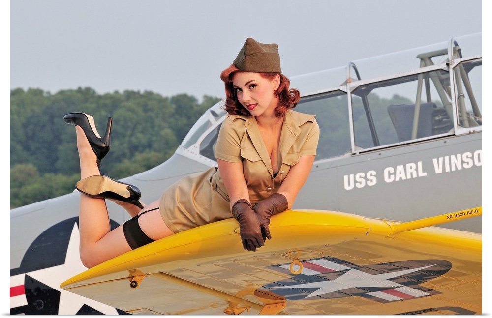 1940's style pin-up girl lying on a T-6 Texan training aircraft.